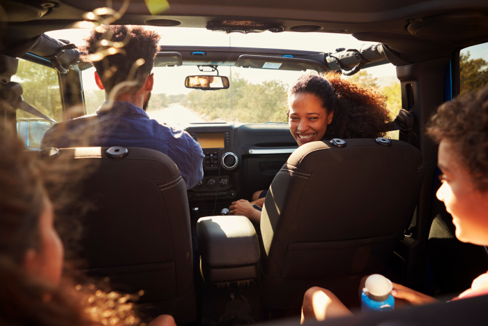 Young family having fun in car