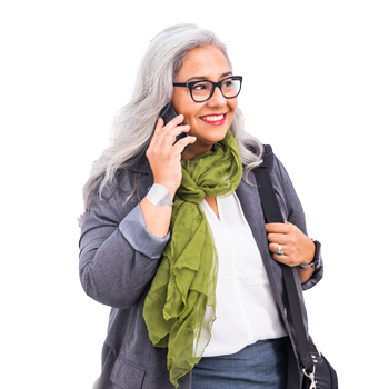 Older woman with long gray hair   and glasses listening to phone