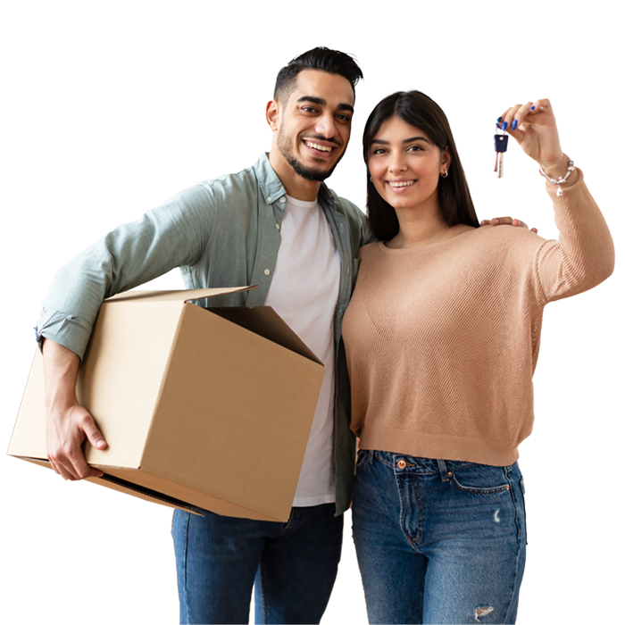 New homeowners holding moving box and keys to their new home